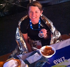 Katrina Cousins at the end of the Ironman wrapped in foil